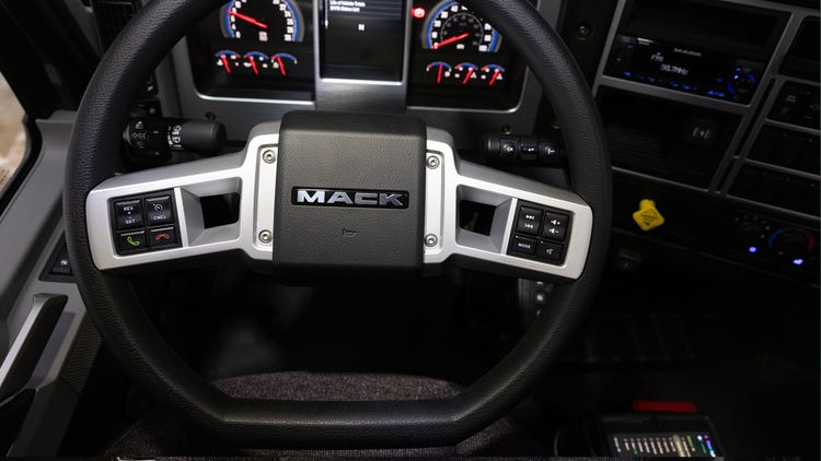Mack MD Series steering wheel with integrated controls, illuminated gauges, and a detailed dashboard.