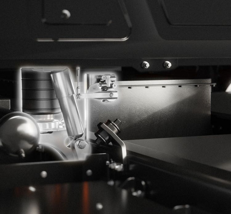 Close-up of the dual-airbag cab suspension system, designed to enhance driver comfort during long workdays