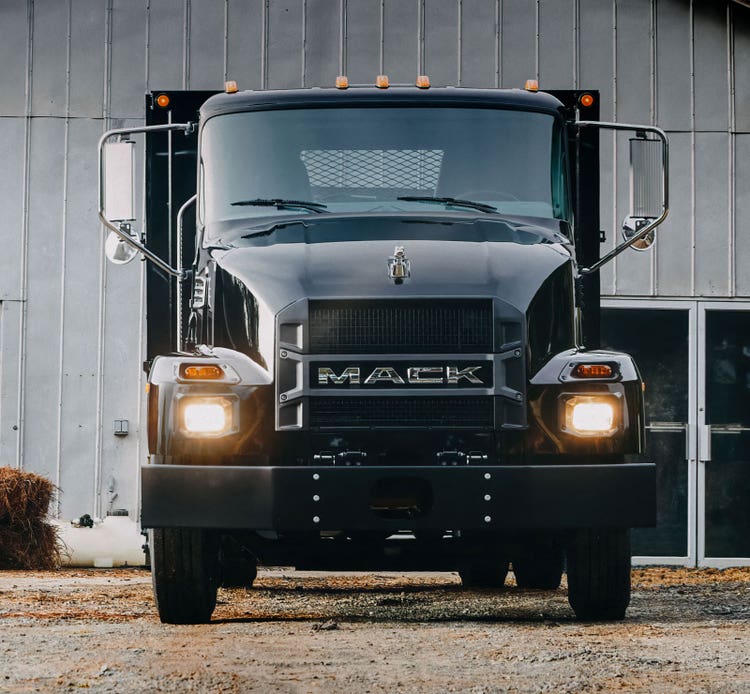 Front view of a black Mack truck with optional AirRide suspension featuring dual airbags for a smoother ride.